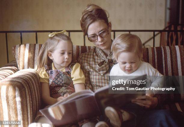 mom and her little kids looking book - old brother stock pictures, royalty-free photos & images