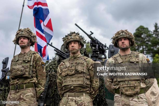 British soldiers stand in front of a military vehicle during a press conference of the Polish and Lithuanian president following a joint visit of the...