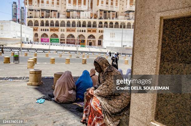 Women rest in the shade as they face the very hot desert weather, during the annual hajj pilgrimage in the Saudi holy city of Mecca, on July 6, 2022....