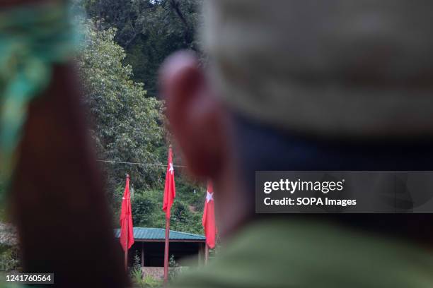 People's Defence force flag is hoisted on poles at their camp. The People's Defence force is the armed wing of Myanmar's National Unity Government ,...