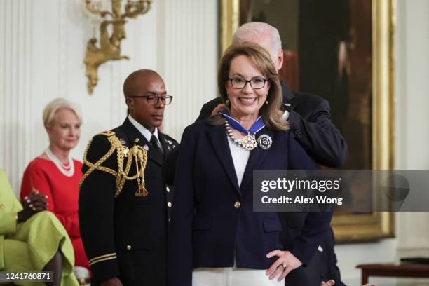 President Joe Biden presents the Presidential Medal of Freedom to gun control advocate and former Rep. Gabrielle Giffords during a ceremony in the...