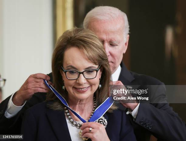 President Joe Biden presents the Presidential Medal of Freedom to gun control advocate and former Rep. Gabrielle Giffords during a ceremony in the...