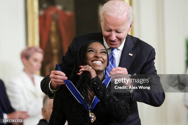 President Joe Biden presents the Presidential Medal of Freedom to Simone Biles, Olympic gold medal gymnast and mental health advocate, during a...