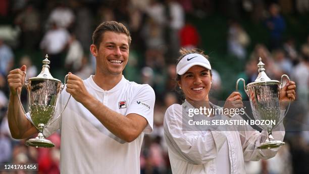 Britain's Neal Skupski and US player Desirae Krawczyk celebrate with their trophies after winning against Australia's Matthew Ebden and Samantha...