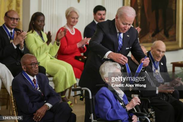 President Joe Biden presents the Presidential Medal of Freedom to retired Air Force Brigadier General Wilma Vaught, one of the most decorated women...