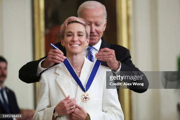President Joe Biden presents the Presidential Medal of Freedom to Megan Rapinoe, soccer player and advocate for gender pay equality, during a...