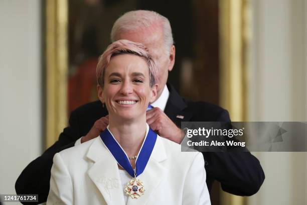 President Joe Biden presents the Presidential Medal of Freedom to Megan Rapinoe, soccer player and advocate for gender pay equality, during a...