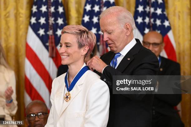 President Joe Biden presents US soccer player Megan Rapinoe with the Presidential Medal of Freedom, the nation's highest civilian honor, during a...