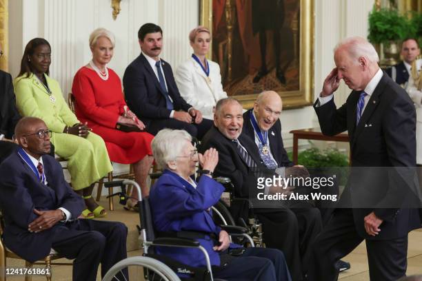 President Joe Biden salutes after he presented the Presidential Medal of Freedom to retired Air Force Brigadier General Wilma Vaught, one of the most...