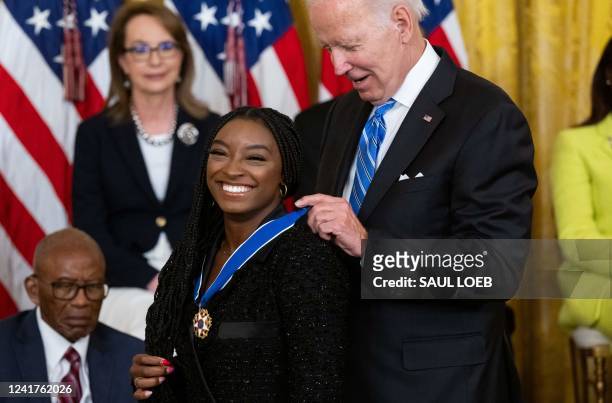 President Joe Biden presents Gymnast Simone Biles with the Presidential Medal of Freedom, the nation's highest civilian honor, during a ceremony...