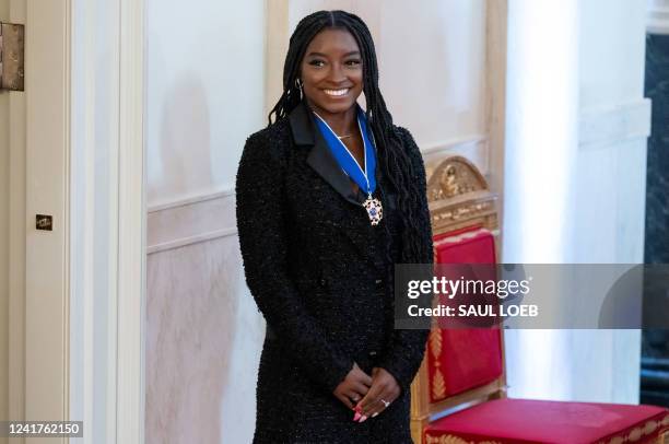 Gymnast Simone Biles looks on after receiving the Presidential Medal of Freedom, the nation's highest civilian honor, during a ceremony honoring 17...