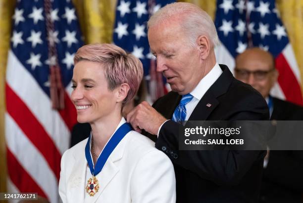 President Joe Biden presents US soccer player Megan Rapinoe with the Presidential Medal of Freedom, the nation's highest civilian honor, during a...