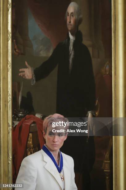 Megan Rapinoe, soccer player and advocate for gender pay equality, stands near a portrait of former President George Washington after receiving the...