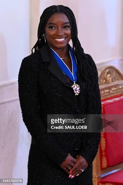 Gymnast Simone Biles looks on after receiving the Presidential Medal of Freedom, the nation's highest civilian honor, during a ceremony honoring 17...