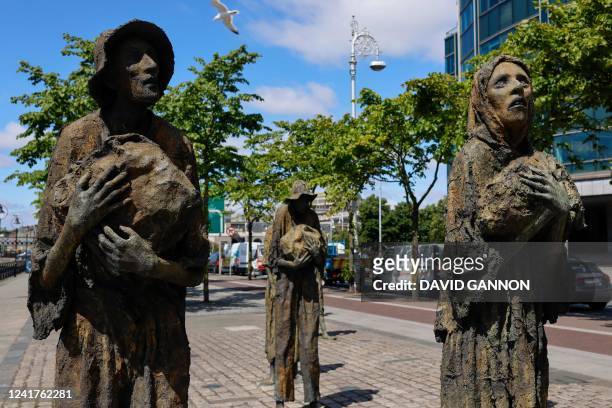 Irish sculptor Rowan Gillespie's Famine Memorial statues are pictured on the banks of the River Liffey in Dublin, Ireland on July 7, 2022. - The...