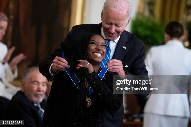 President Joe Biden presents the Presidential Medal of Freedom to gymnast Simone Biles, one of this years 17 recipients to receive the nation's...