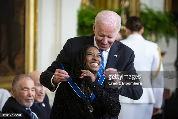 President Joe Biden presents the Presidential Medal of Freedom to Simone Biles, Olympic gymnast, during a ceremony in the East Room of the White...