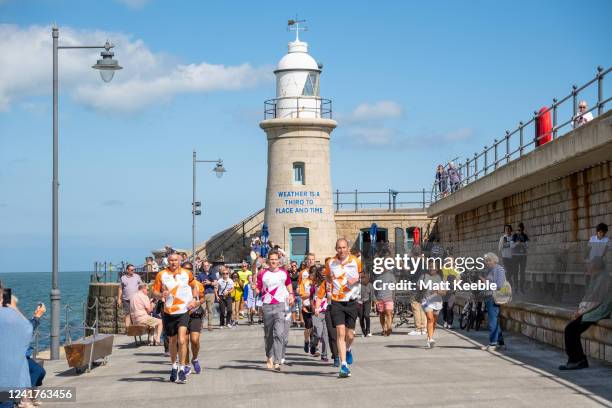 Maj Chris Brannigan takes part in The Queen's Baton Relay as it visits Folkestone as part of the Birmingham 2022 Queens Baton Relay on July 7, 2022...