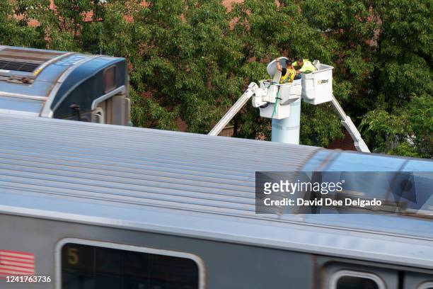 Workers install a Link5G-transmitting smart pole which sits atop of a LinkNYC kiosk on July 7, 2022 in The Bronx borough of New York City. The...