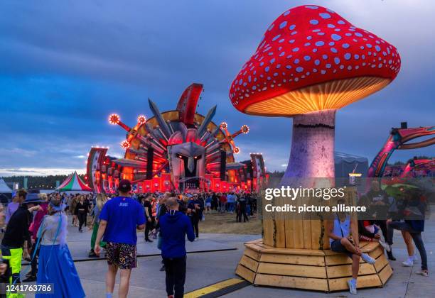 July 2022, Mecklenburg-Western Pomerania, Neustadt-Glewe: Spectators celebrate in front of one of the numerous stages of the electro festival...