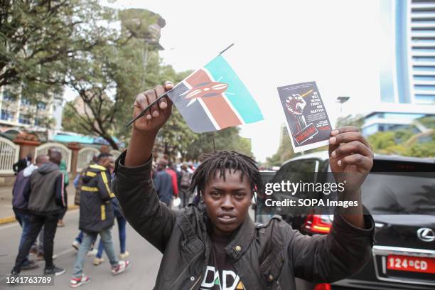 Kenyans man holds a Kenyan flag during a march to decry the high cost of living on Saba Saba Day. Kenyan activists from the Social Justice Centres...