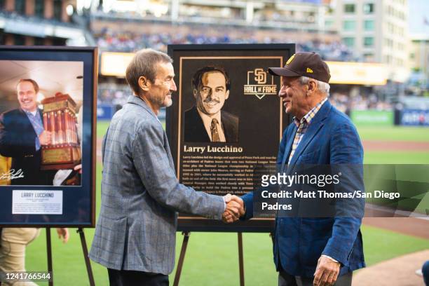Former San Diego Padres president and CEO Larry Lucchino shakes hands with Padres Chairman Peter Seidler during Lucchinos induction ceremony into the...