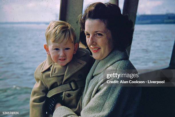 woman with her son sitting in boat - vintage 1950s woman stock pictures, royalty-free photos & images