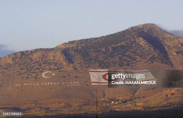 Photo taken on November 21, 2001 shows the flag of the breakaway Turkish Republic of Northern Cyprus painted on the Kyrenia mountain range as seen...