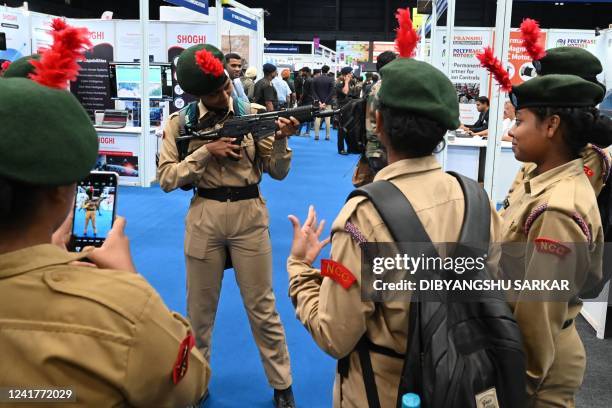 National Cadet Corps cadets poses for a picture with a rifle on the display at a Defence and Technology Expo organised by the Easter Command of...