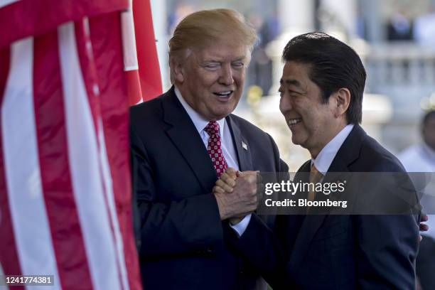 President Donald Trump, left, greets Shinzo Abe, Japan's prime minister, as he arrives to the West Wing of the White House in Washington, D.C., U.S.,...