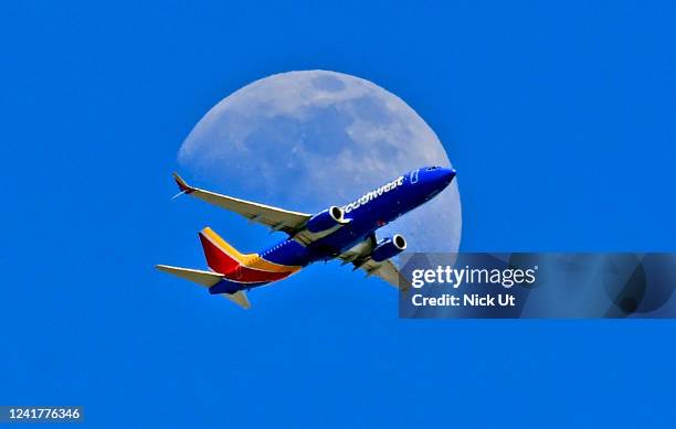 July 07: A Southwest Airlines Boeing 737 plane files in front of the moon on July 07, 2022 in WHITTIER , CA.