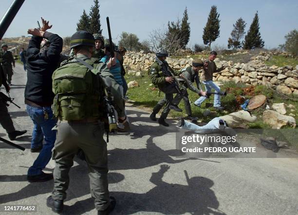 Israeli border police beat residents of the northern West Bank town of Beit Surik, on the edge of Jerusalem, as they try to prevent Israeli...