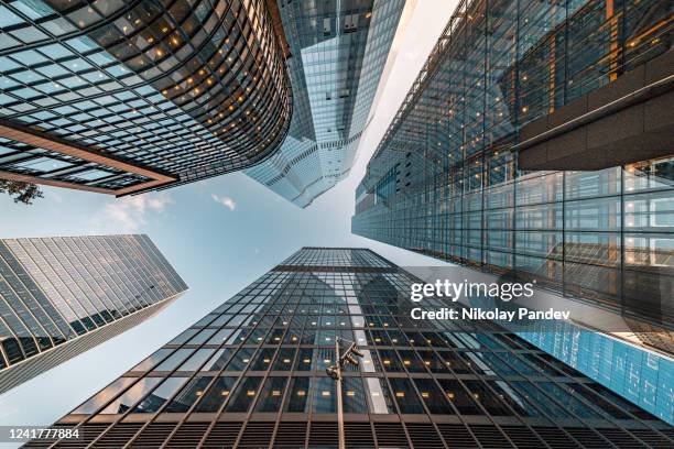 looking directly up at the skyline of the financial and business brand new district in central city of london on a bright sunny afternoon - creative stock image - brexit business stock pictures, royalty-free photos & images