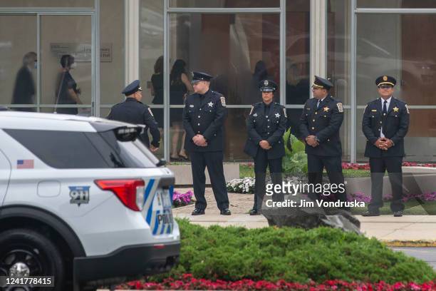 Police stand in line ahead of a memorial service outside of the North Shore Congregation Israel Synagogue July 8, 2022 in Glencoe, Illinois. The...