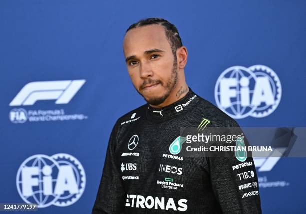 Mercedes' British driver Lewis Hamilton walks back to the pits after crashing during the qualifying session of the Red Bull Ring race track in...