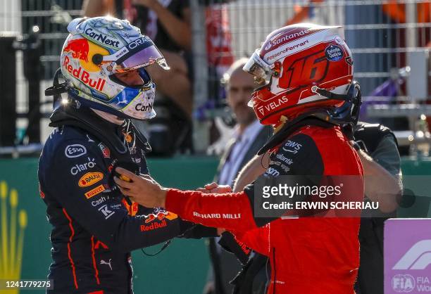 Red Bull Racing's Dutch driver Max Verstappen and Ferrari's Monegasque driver Charles Leclerc talk after the qualifying session at the Red Bull Ring...