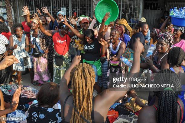 Street vendors of the Arreiou do Sao Paulo market sing and dance while they mourn the death of former Angolan President Jose Eduardo Dos Santos in...