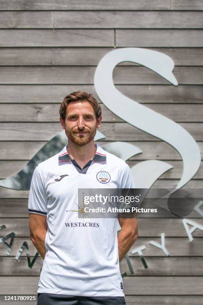 Joe Allen poses for a picture after signing a contract with Swansea City at Fairwood Training Ground on July 08, 2022 in Swansea, Wales.