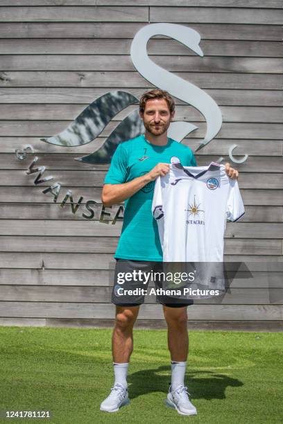 Joe Allen poses for a picture after signing a contract with Swansea City at Fairwood Training Ground on July 08, 2022 in Swansea, Wales.