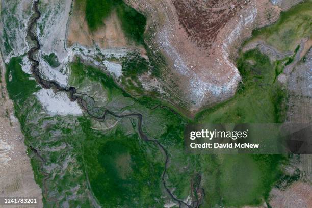 In an aerial view, very low water levels are seen at Castaic Lake reservoir as drought continues on July 8, 2022 near Castaic, California. The...