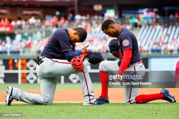 Washington Nationals right fielder Juan Soto and Washington Nationals center fielder Victor Robles kneel on the field prior to the Major League...
