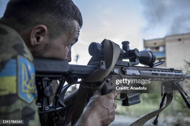 Ukrainian sniper calibrates the telescopic sight of his rifle during heavy shelling in Siversk, Ukraine, July 08th, 2022.