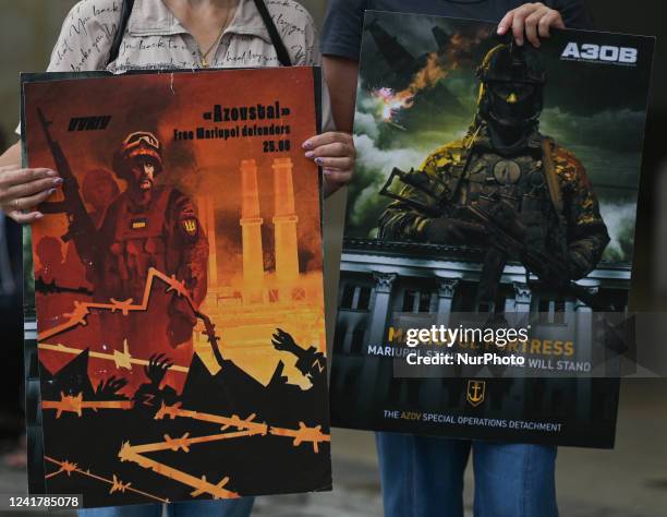 Protesters are holding posters with images related to the Azov Regiment. Ukrainians living in Krakow seen during their 134th day of the 'NATO Close...