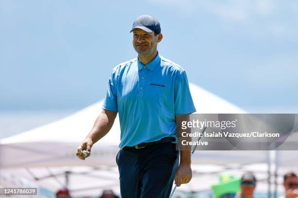 Former NFL football player Tony Romo reacts after making a putt on the 17th green during Round One of the 2022 American Century Championship at...