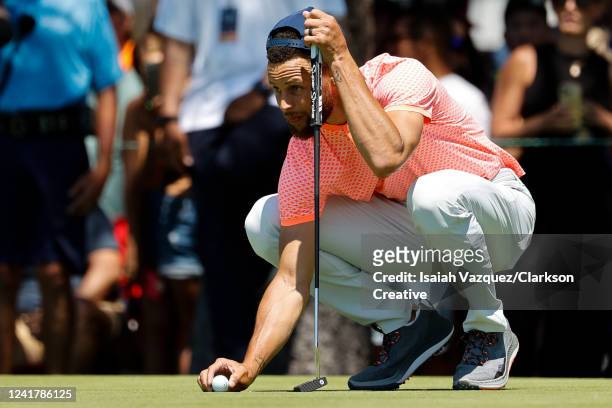 Basketball player Stephen Curry places the ball on the 17th putting green during Round One of the 2022 American Century Championship at Edgewood...