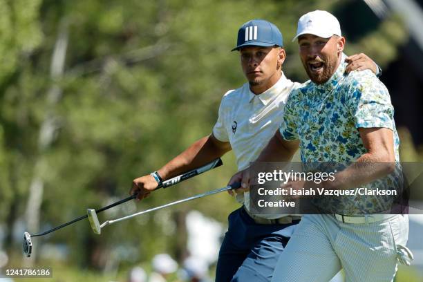 Football players Travis Kelce and Patrick Mahomes react to Kelce making a putt for an eagle on the 18th hole during Round One of the 2022 American...