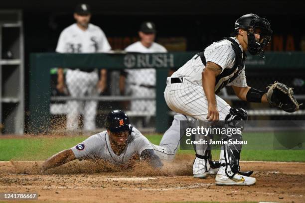 Jonathan Schoop of the Detroit Tigers slides in to home plate to score a run in the seventh inning as catcher Seby Zavala of the Chicago White Sox...