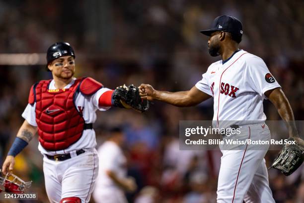 Jackie Bradley Jr. Of the Boston Red Sox reacts with Christian Vazquez after pitching during the ninth inning of a game against the New York Yankees...