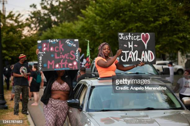Demonstrators hold signs during a vigil in honor of Jayland Walker on July 8, 2022 in Akron, Ohio. Walker was shot and killed by members of the Akron...
