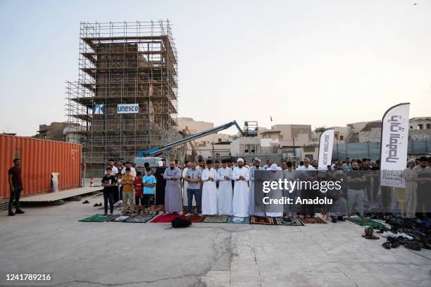 Muslims arrive to perform Eid al-Adha prayer among the ruins of the city's oldest mosque, The Great Mosque of al-Nuri which was detonated by Daesh in...